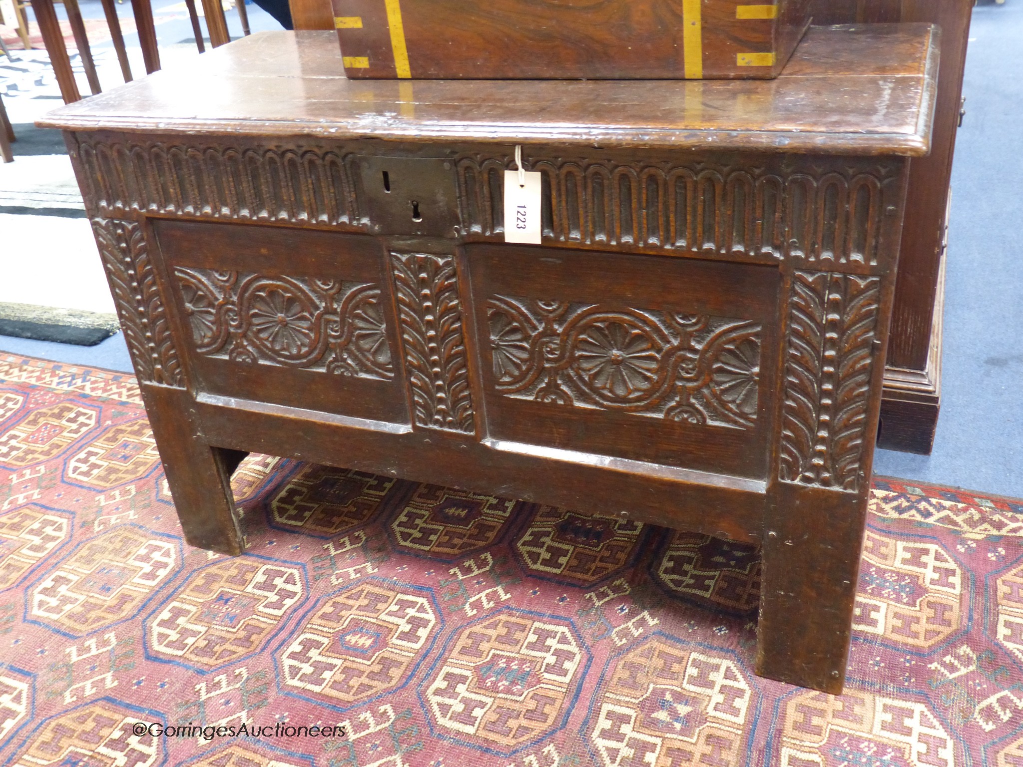 A 17th century carved boarded and panelled oak chest with rectangular moulded top, length 97cm, depth 48cm, height 64cm